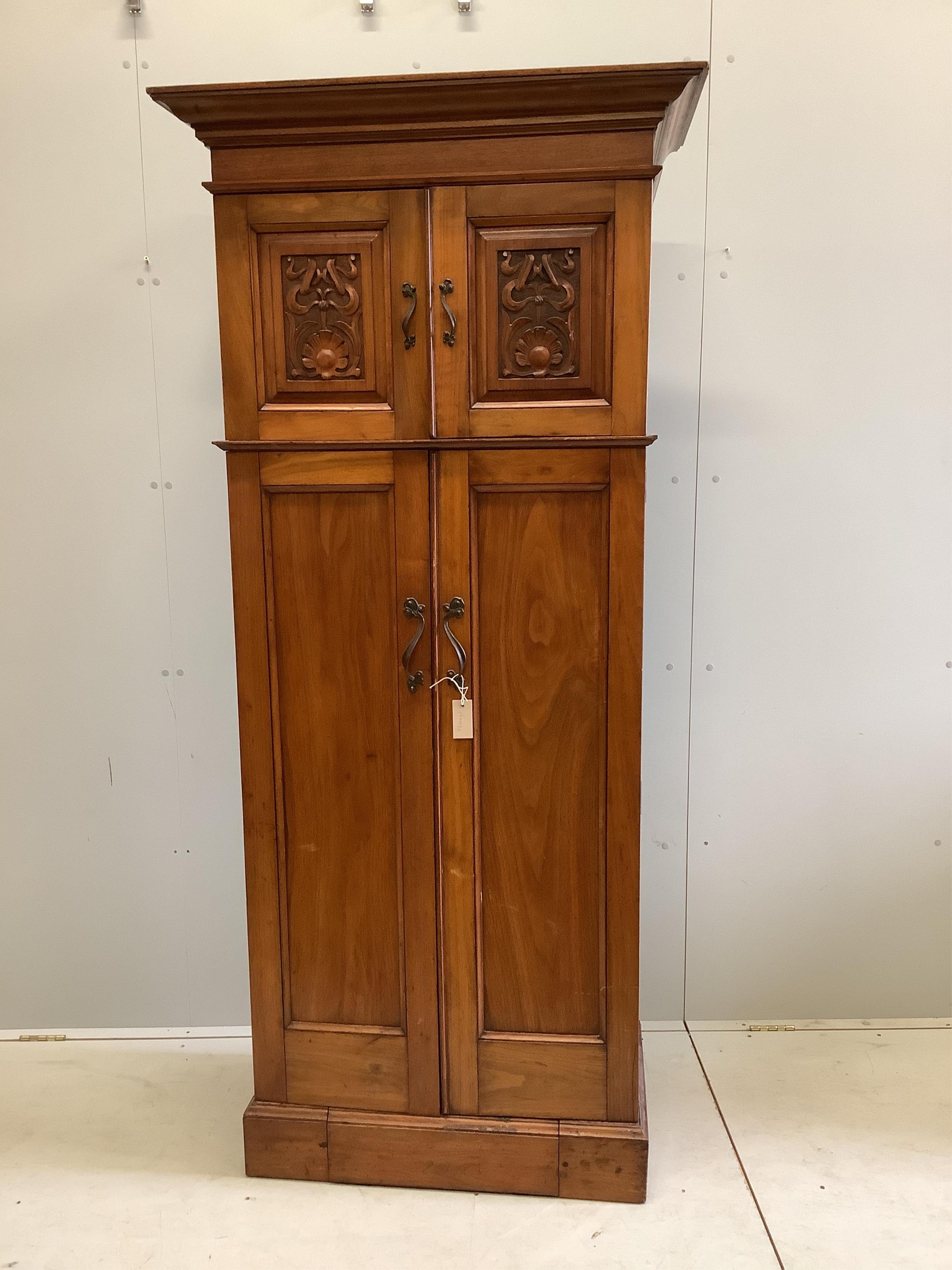 An Art Nouveau walnut gentleman's compactum wardrobe, width 77cm, depth 44cm, height 198cm. Condition - fair to good